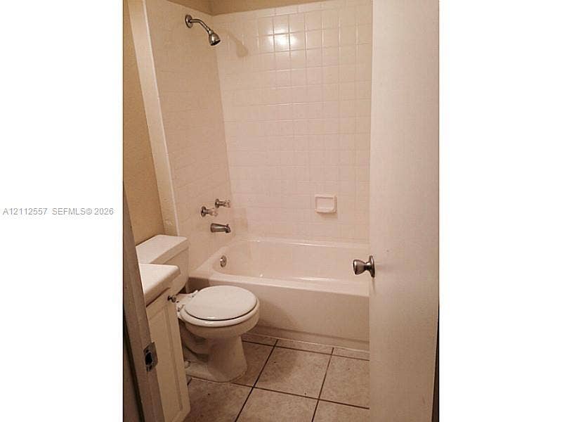 2121 NW 96th Terrace, #14J, Pembroke Pines, Pembroke Pines, FL 33024 Full bathroom featuring a tub-shower combination with tiled surround, white vanity, ceramic tile flooring, and integrated shower fixtures