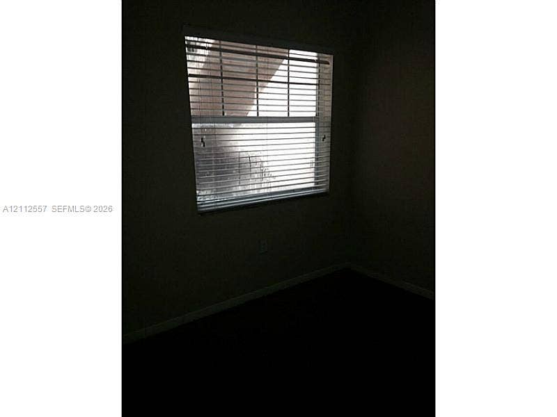 2121 NW 96th Terrace, #14J, Pembroke Pines, Pembroke Pines, FL 33024 Single-hung window featuring horizontal blinds and neutral-toned wall paint