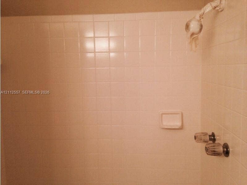 2121 NW 96th Terrace, #14J, Pembroke Pines, Pembroke Pines, FL 33024 Shower stall featuring white square tile surround, built-in soap dish, and wall-mounted shower head with dual-handle controls