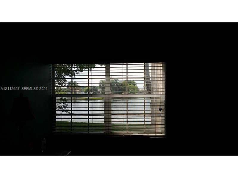 2121 NW 96th Terrace, #14J, Pembroke Pines, Pembroke Pines, FL 33024 Horizontal slat blinds covering a window providing water frontage and exterior foliage