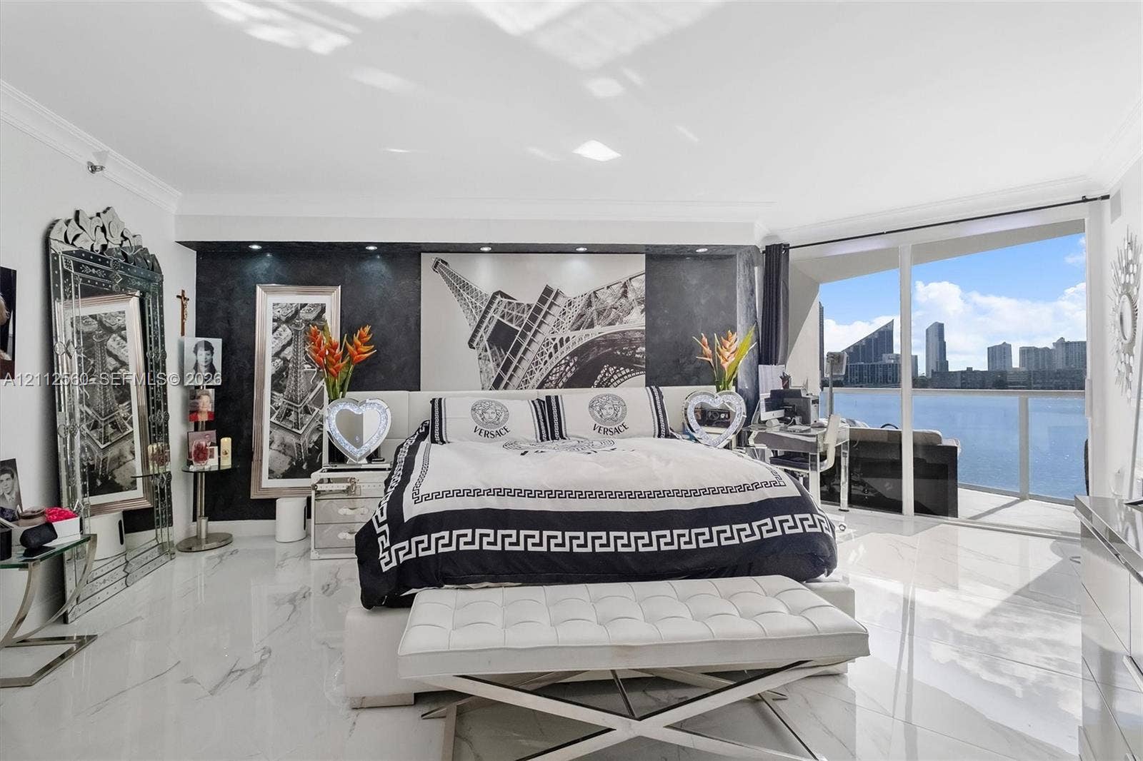 4000 Island Boulevard, #701, Aventura, FL 33160 High-gloss tile flooring, floor-to-ceiling glass sliding doors, recessed ceiling lighting, and a dark stone-finish accent wall