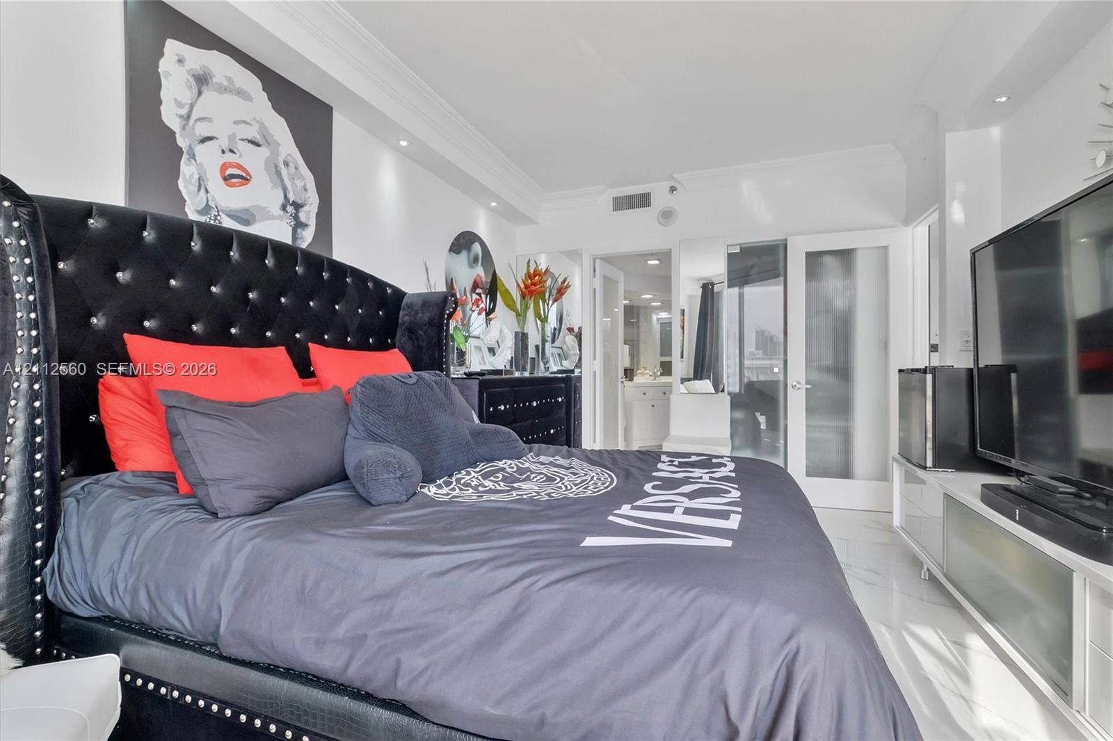 4000 Island Boulevard, #701, Aventura, FL 33160 Polished stone flooring, recessed ceiling lighting, crown molding, and glass-paneled interior doors
