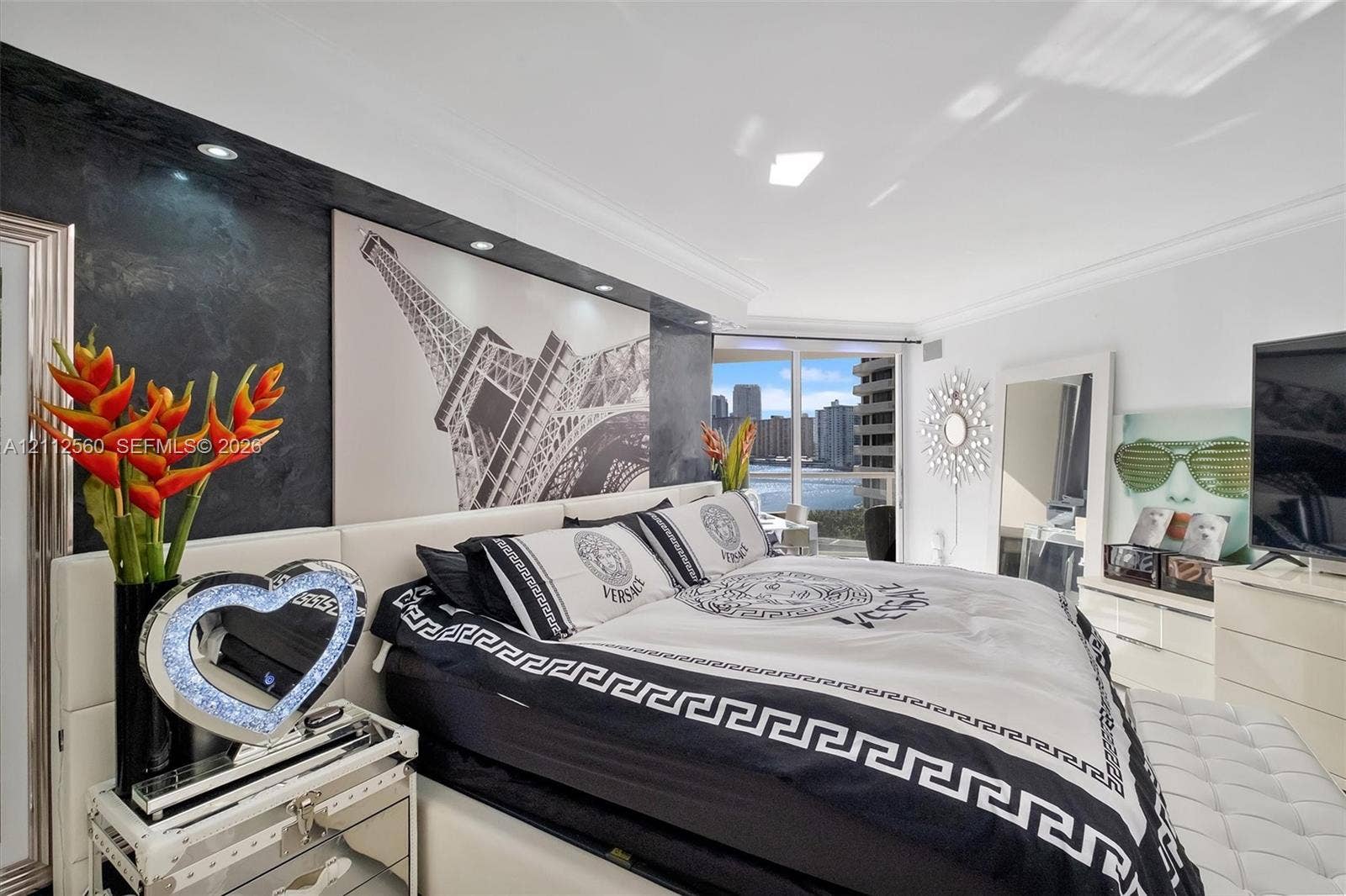 4000 Island Boulevard, #701, Aventura, FL 33160 Textured charcoal feature wall with integrated recessed lighting, floor-to-ceiling glass sliding doors, and crown molding