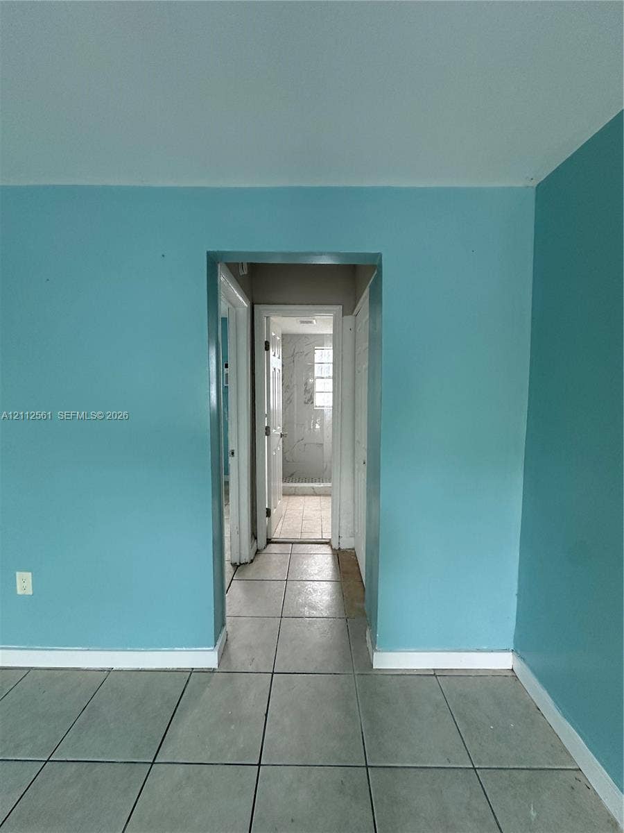 6901 NW 8th Avenue, #2, Miami, Miami, FL 33150 Square tile flooring with a visible doorway leading to a tiled shower enclosure