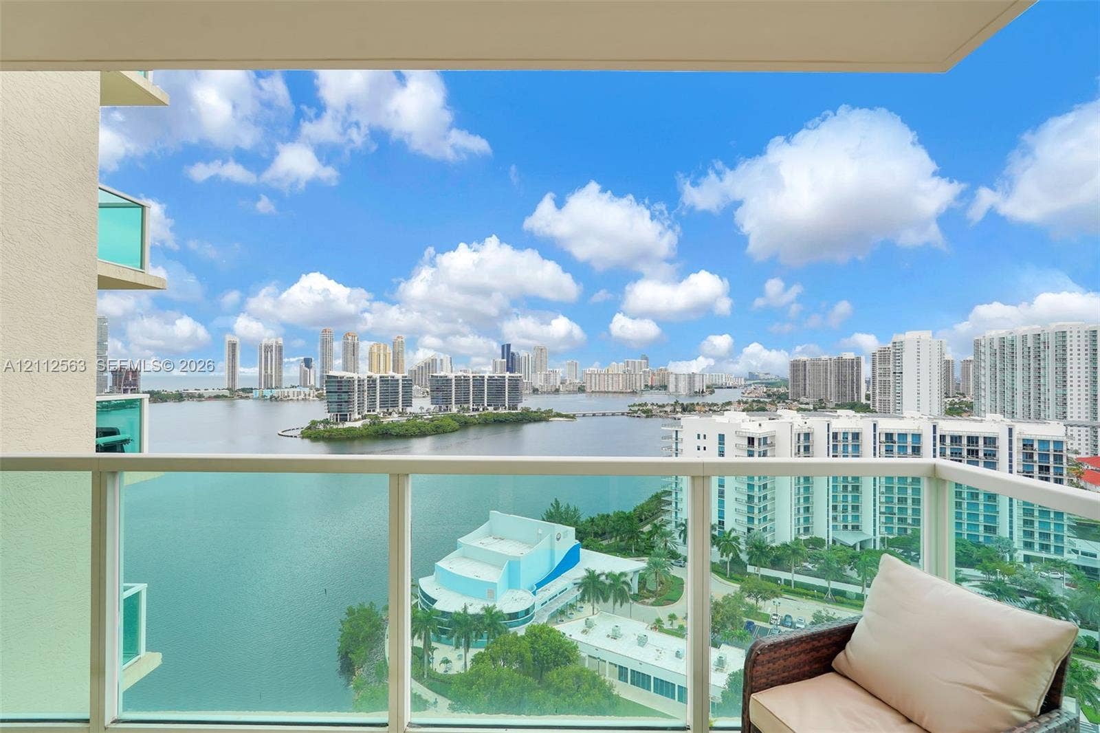 3330 NE 190th Street, #2016, Aventura, FL 33180 Private balcony featuring glass panel railing and panoramic waterfront and city skyline scenery