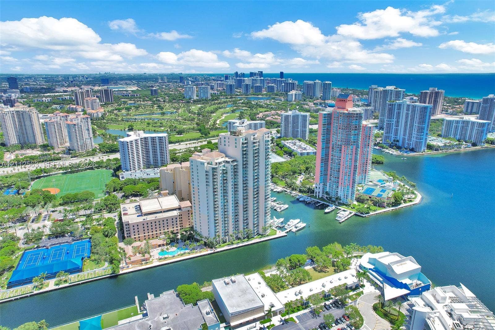 3330 NE 190th Street, #2016, Aventura, FL 33180 Aerial perspective featuring a waterfront high-rise development, a deep-water marina, proximity to coastal waterways, and urban skyline surroundings