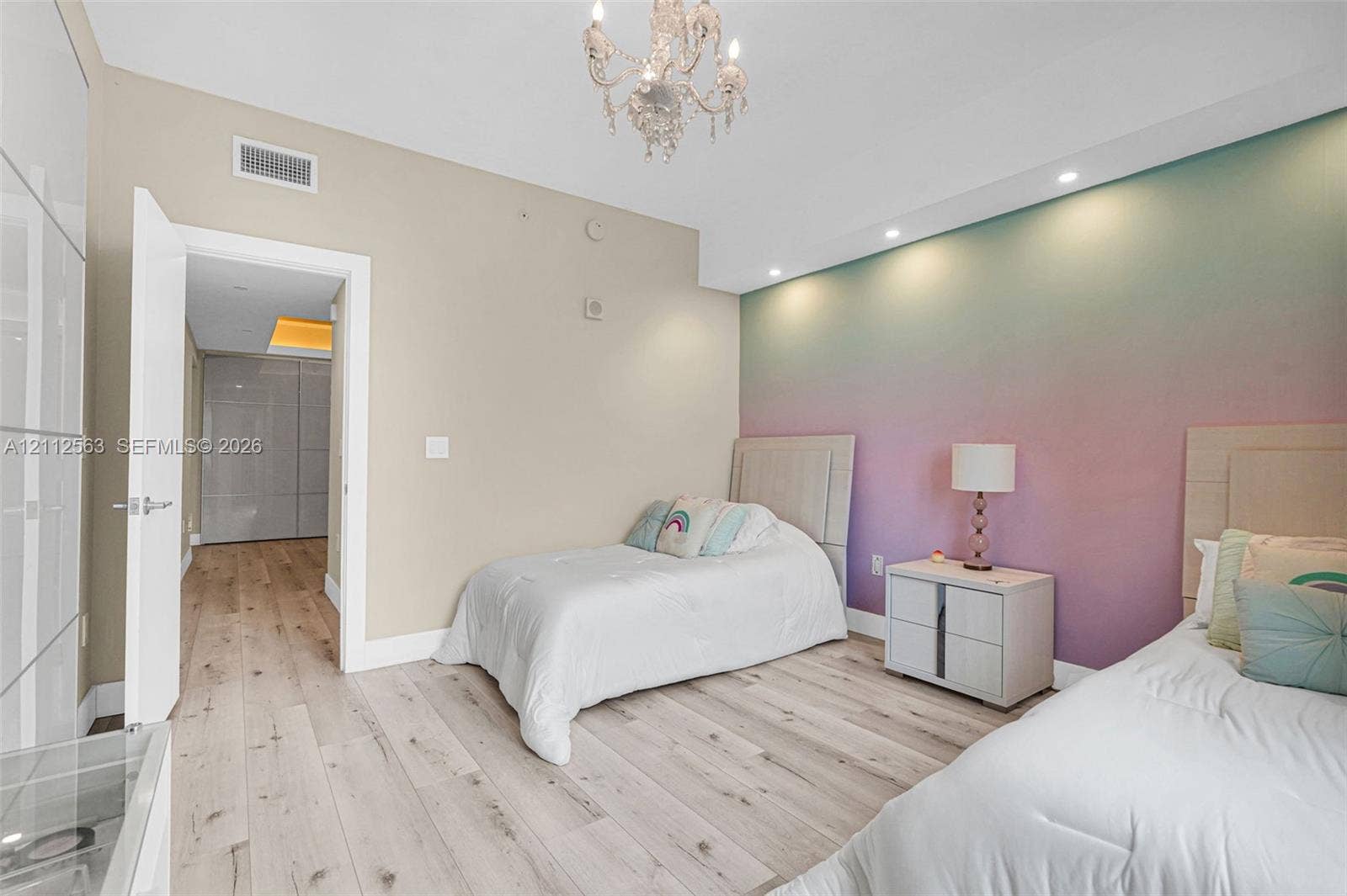 3330 NE 190th Street, #2016, Aventura, FL 33180 Wood-finish flooring, recessed ceiling lighting, decorative chandelier, and floor-to-ceiling built-in cabinetry