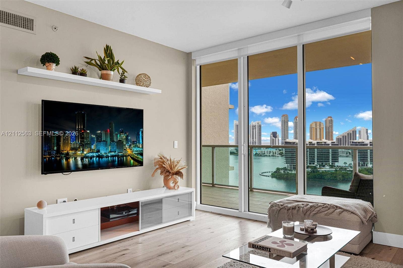 3330 NE 190th Street, #2016, Aventura, FL 33180 Floor-to-ceiling windows, wood-finish flooring, built-in floating shelf, and a private balcony featuring water and skyline scenery