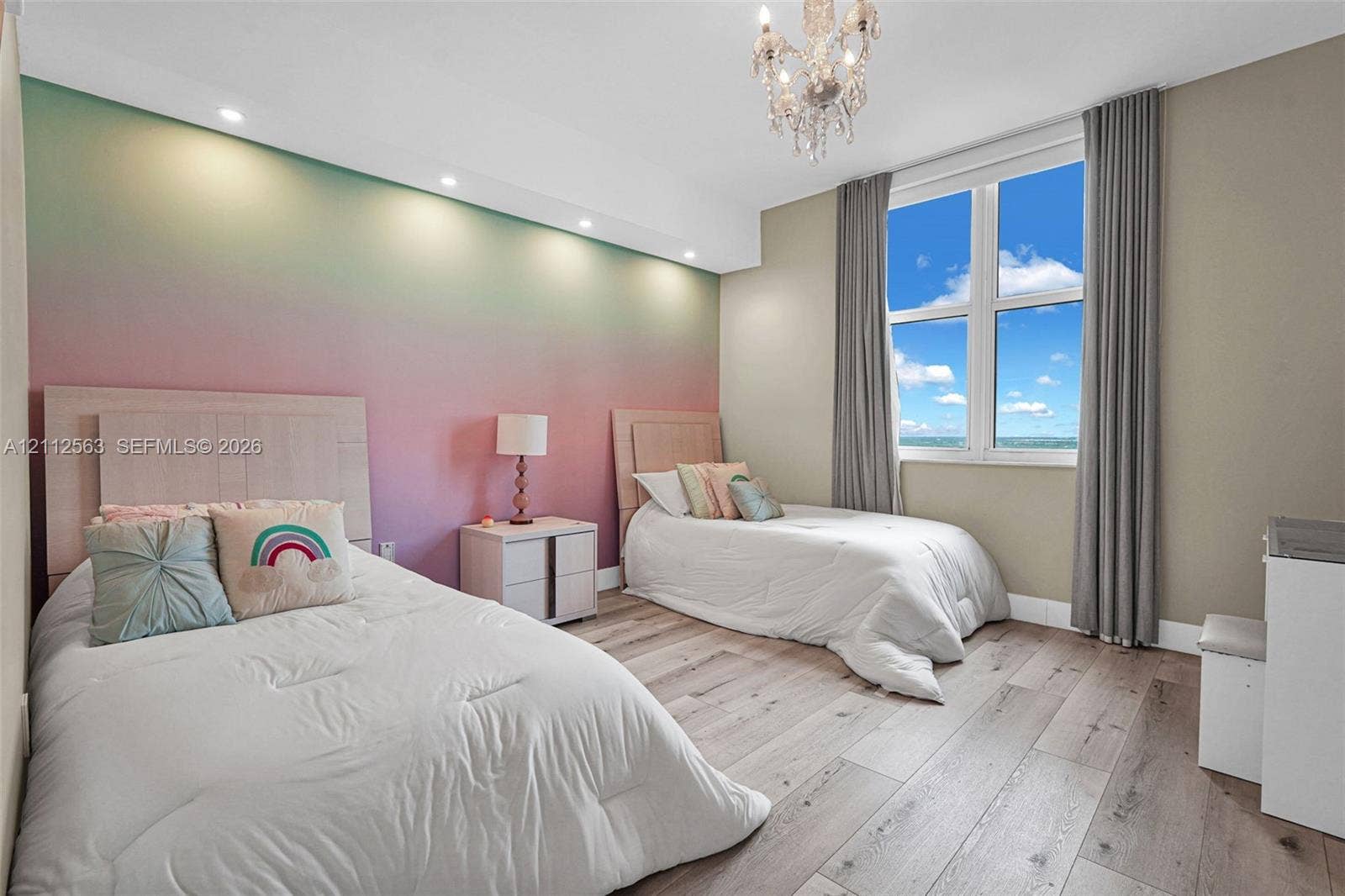 3330 NE 190th Street, #2016, Aventura, FL 33180 Wood-finish flooring, recessed ceiling lighting, a decorative crystal chandelier, and large windows with prominent skyward exposure