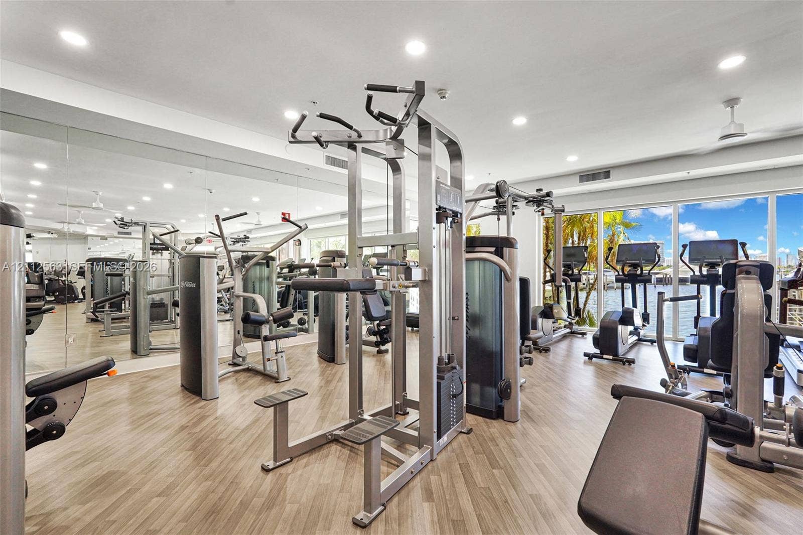 3330 NE 190th Street, #2016, Aventura, FL 33180 Fitness facility featuring full-wall mirrors, wood-finish flooring, recessed lighting, and floor-to-ceiling windows