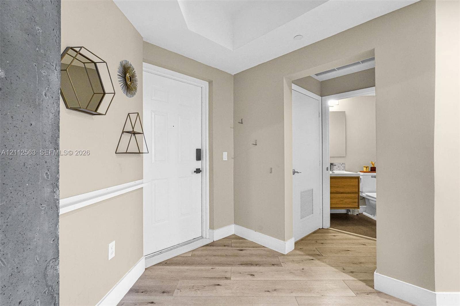 3330 NE 190th Street, #2016, Aventura, FL 33180 Entryway featuring wood-finish flooring, white paneled door with electronic deadbolt, recessed ceiling lighting, and chair rail molding