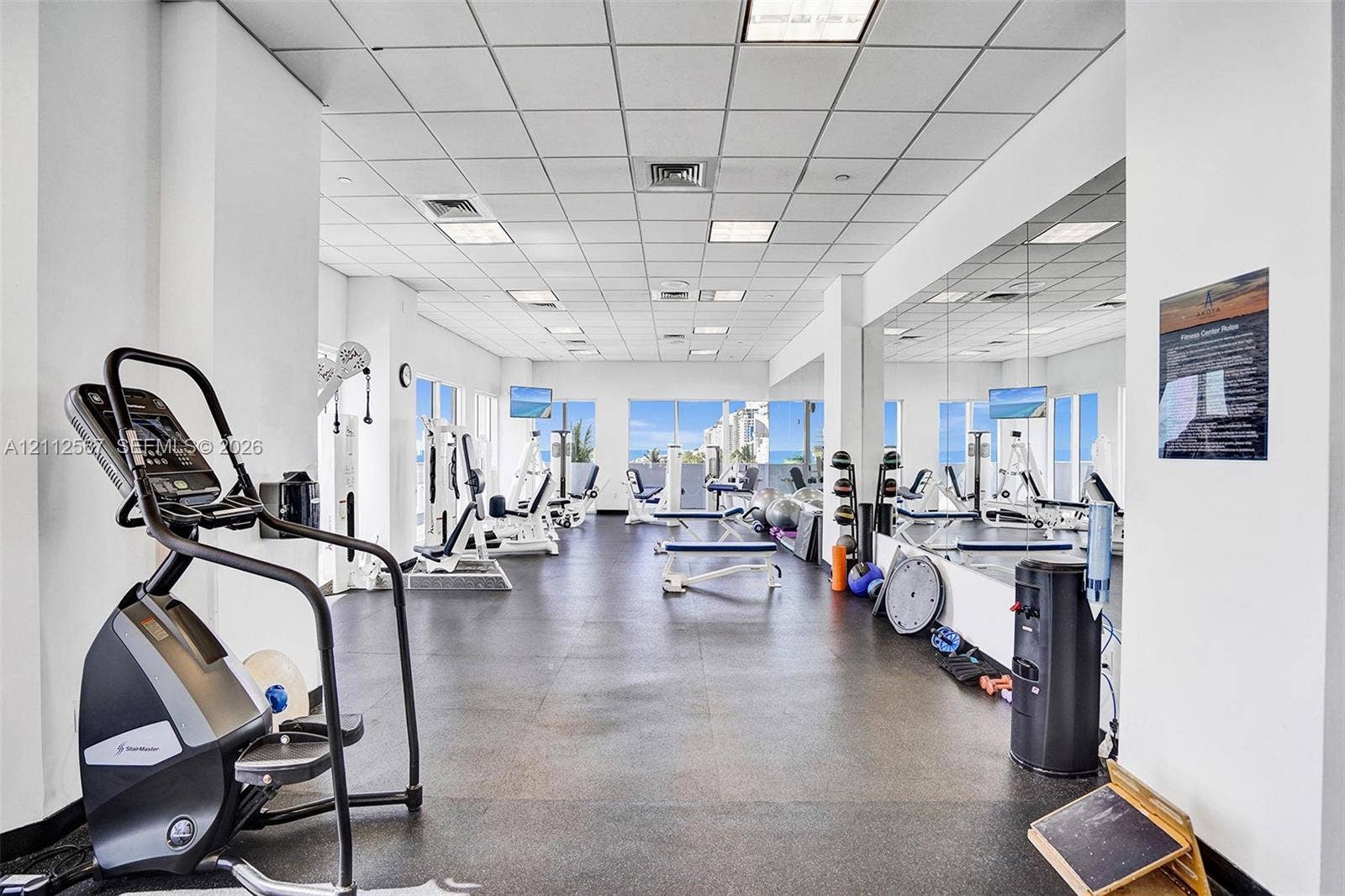 6365 Collins Avenue, #3208, Miami Beach, Miami Beach, FL 33141 Fitness center featuring wall-to-wall mirrors, recessed grid ceiling lighting, impact-resistant rubber flooring, and large windows