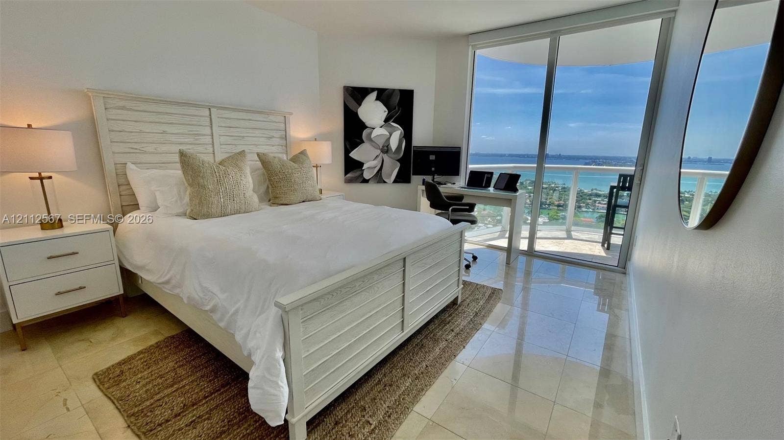 6365 Collins Avenue, #3208, Miami Beach, Miami Beach, FL 33141 Floor-to-ceiling sliding glass doors, polished stone flooring, and expansive wrap-around balcony with coastal scenery