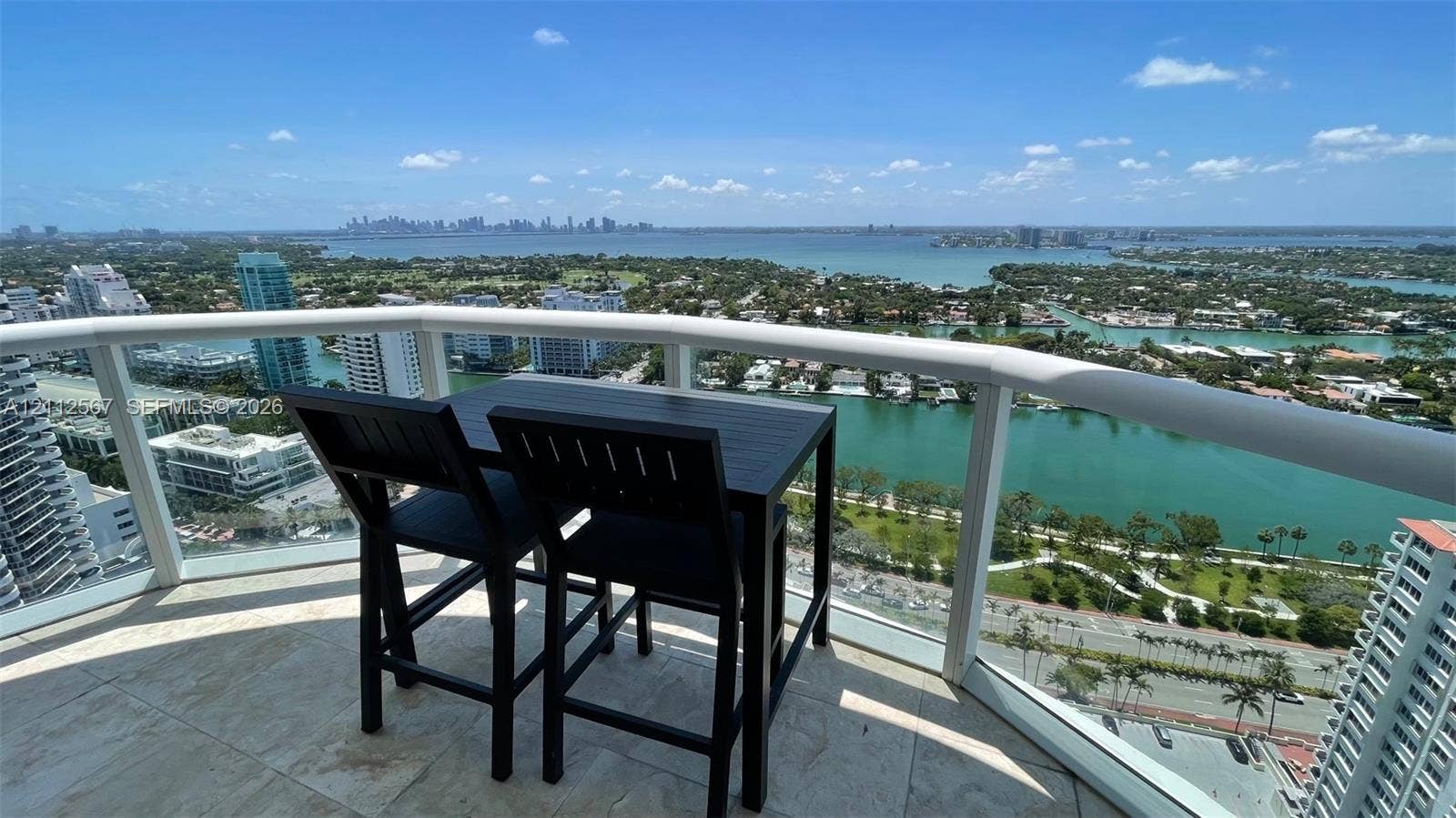 6365 Collins Avenue, #3208, Miami Beach, Miami Beach, FL 33141 Covered balcony featuring stone tile flooring and a curved white railing