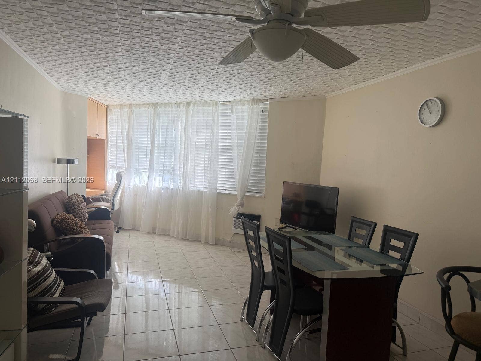 1936 S Ocean Drive, #8B, Hallandale Beach, Hallandale Beach, FL 33009 Large-format tile flooring, textured ceiling with integrated lighting, built-in cabinetry, and expansive window wall with integrated horizontal blinds