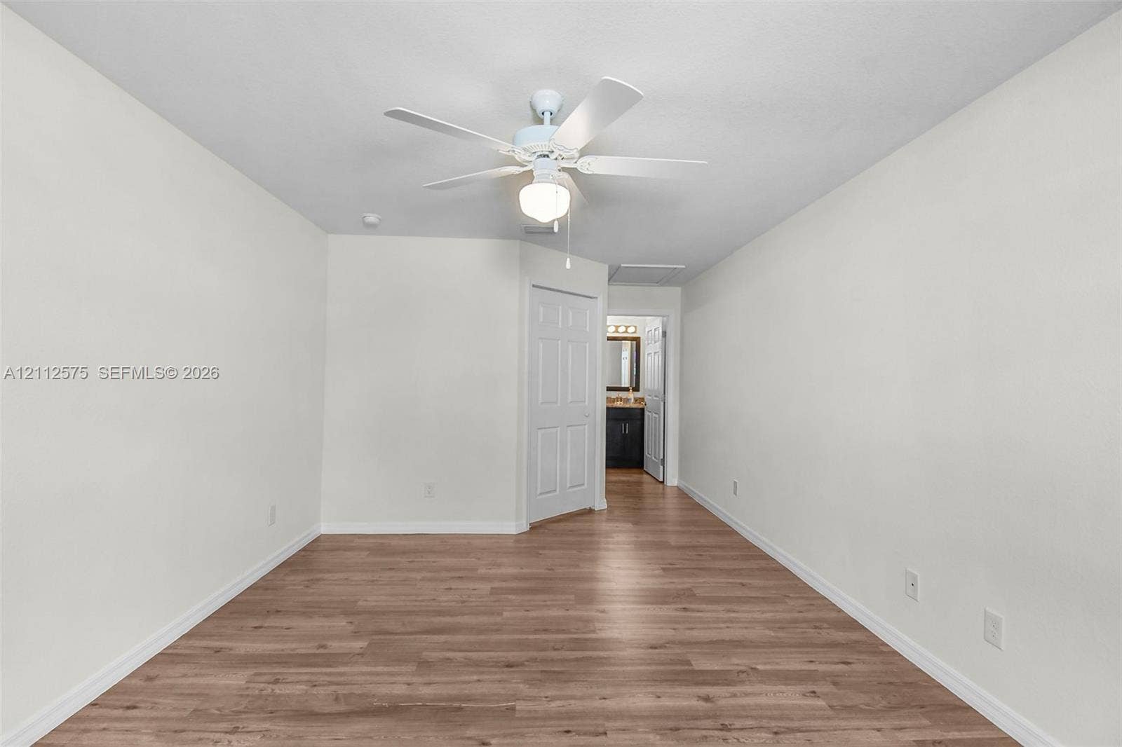 9041 E Broad, Labelle, FL 33935 Interior space featuring wood-finish flooring, white walls, and a ceiling fan with integrated lighting