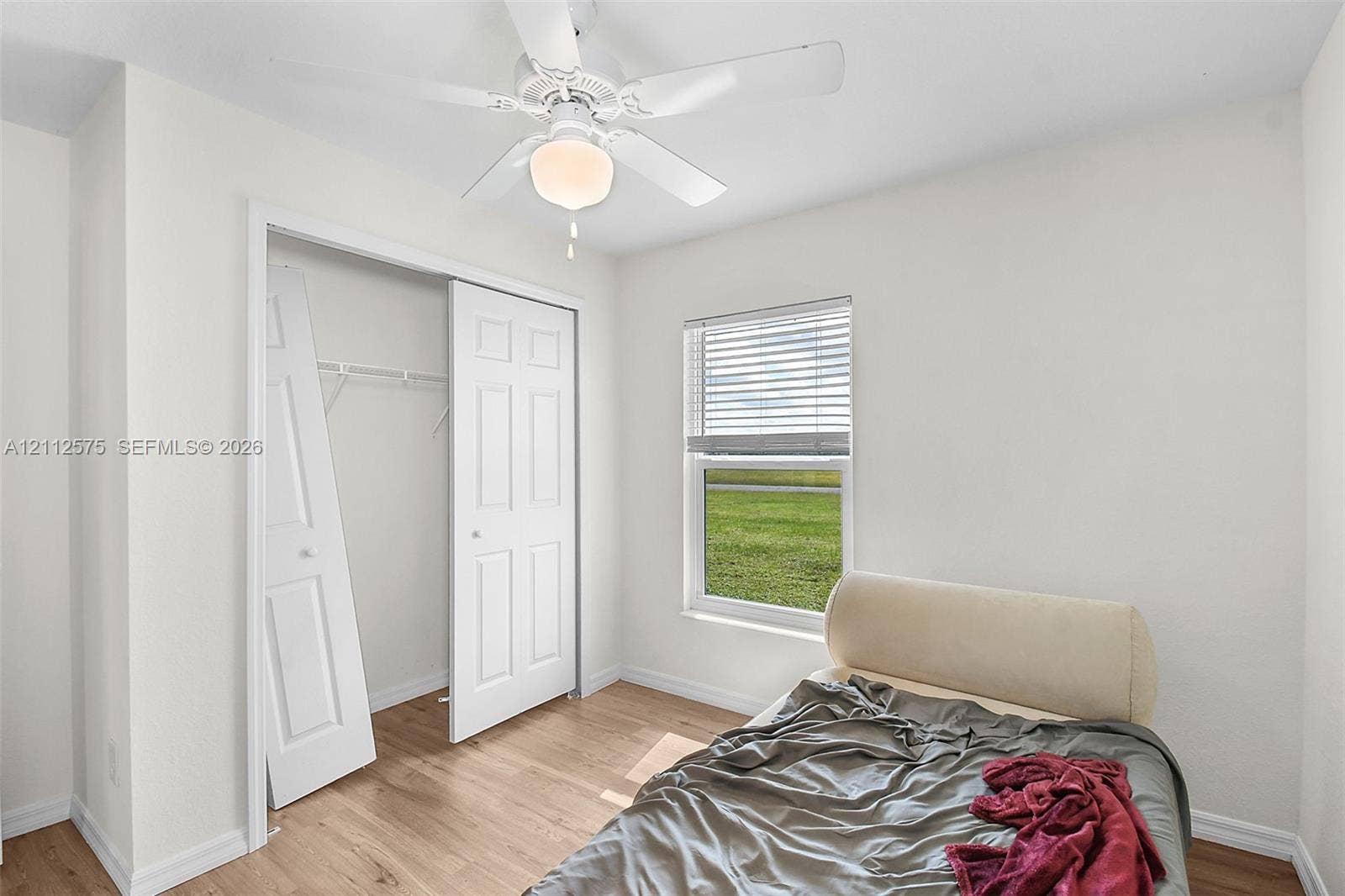 9041 E Broad, Labelle, FL 33935 Wood-finish flooring, ceiling fan with integrated lighting, closet with double doors, and horizontal window blinds