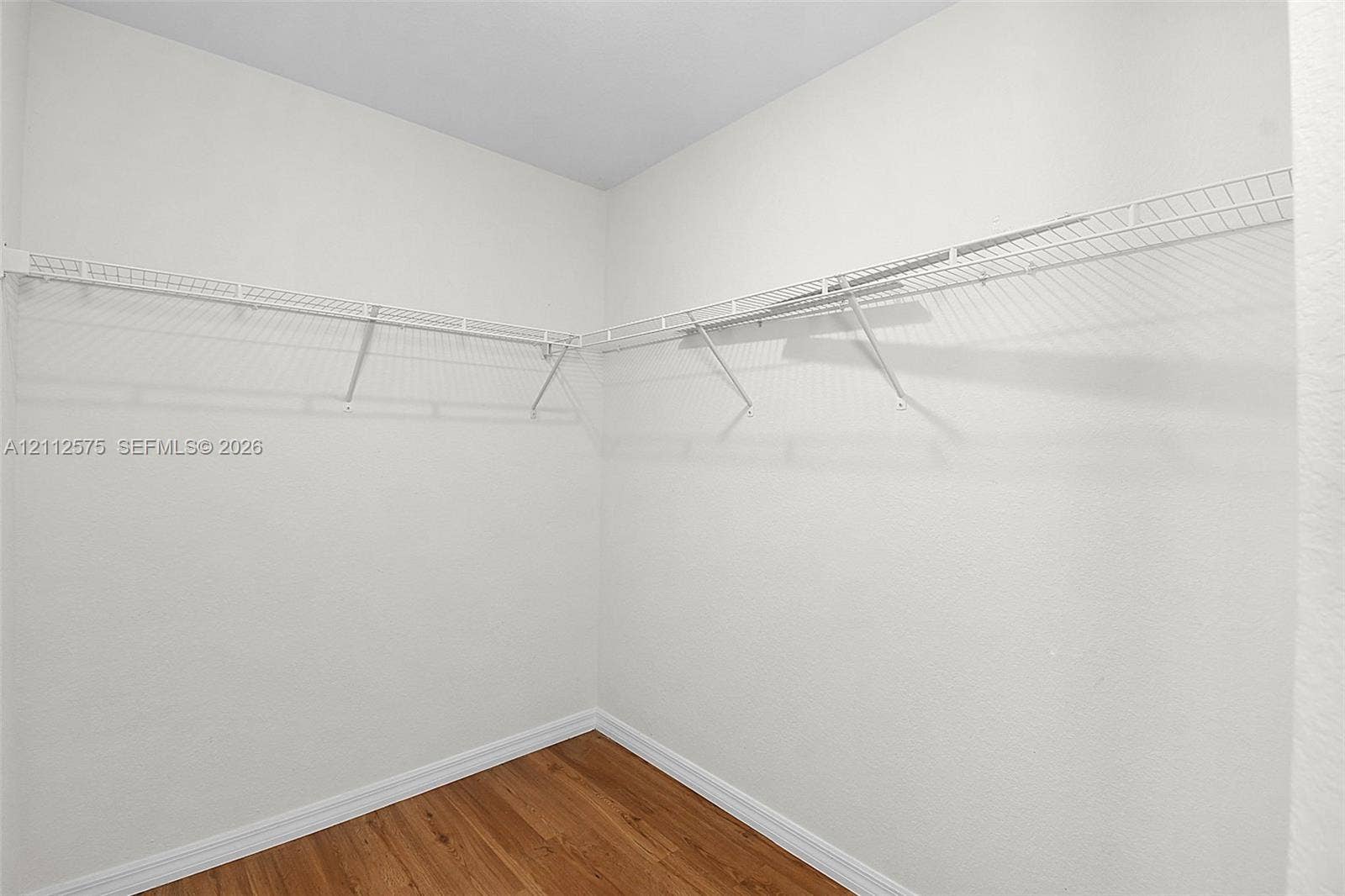 9041 E Broad, Labelle, FL 33935 Walk-in storage area featuring wood-finish flooring and wall-mounted white wire shelving