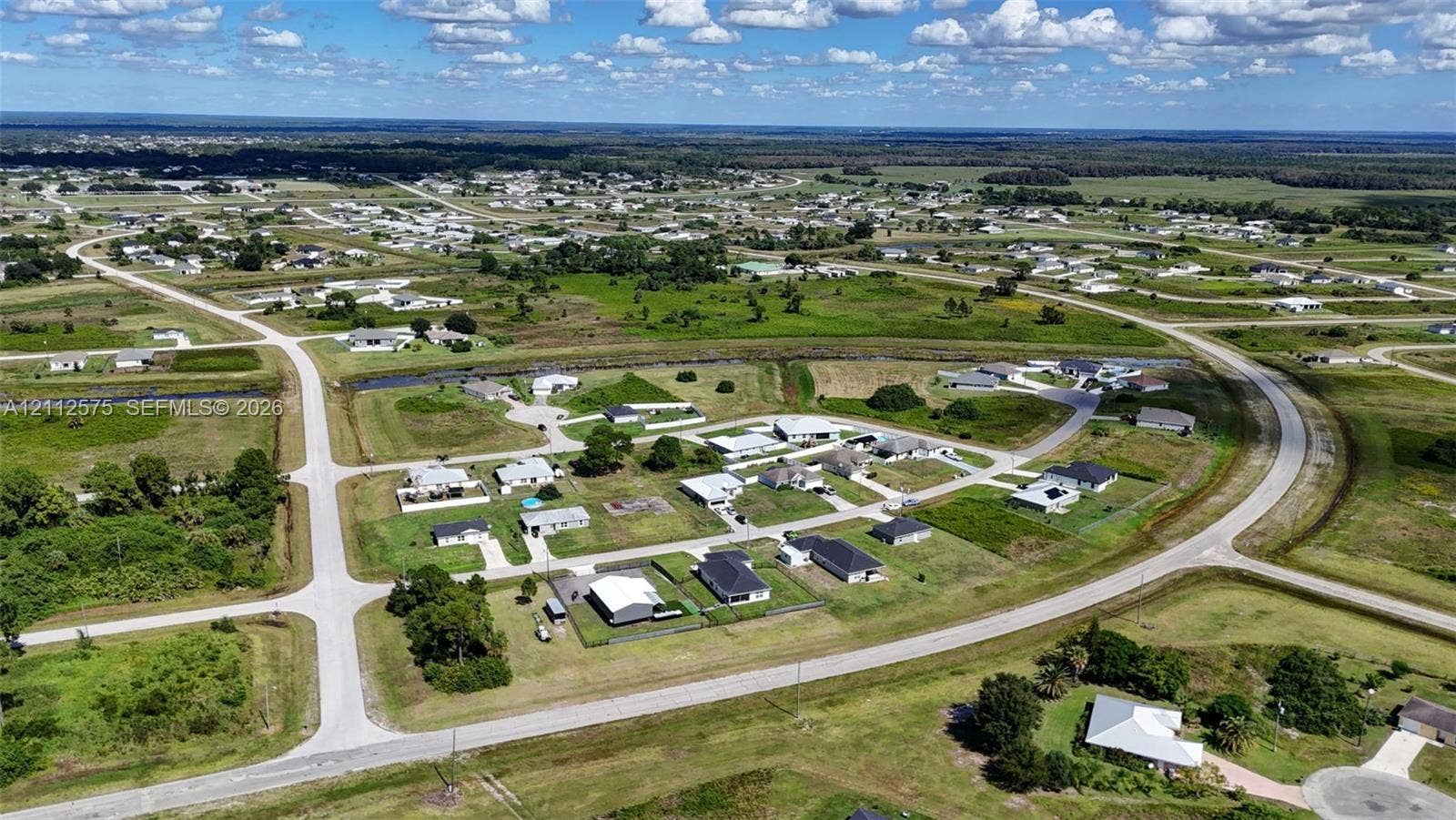 9041 E Broad, Labelle, FL 33935 Aerial perspective of a planned subdivision featuring paved roadway infrastructure, concrete cul-de-sacs, and established residential lots with expansive green space