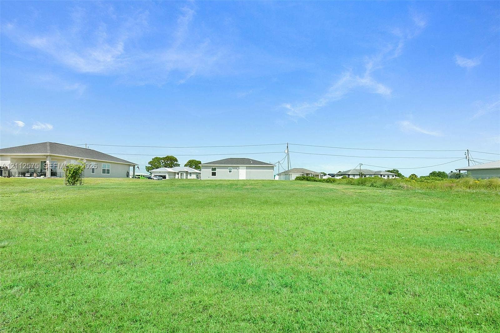 9041 E Broad, Labelle, FL 33935 Expansive open lot featuring level grass terrain and clear horizon lines