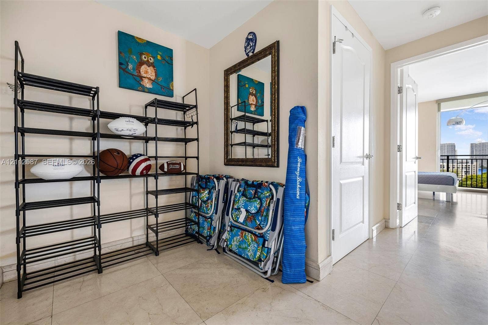 17555 NW Atlantic Boulevard, #1108, Sunny Isles Beach, FL 33160 Interior hall featuring light-toned stone-finish flooring and paneled interior doors