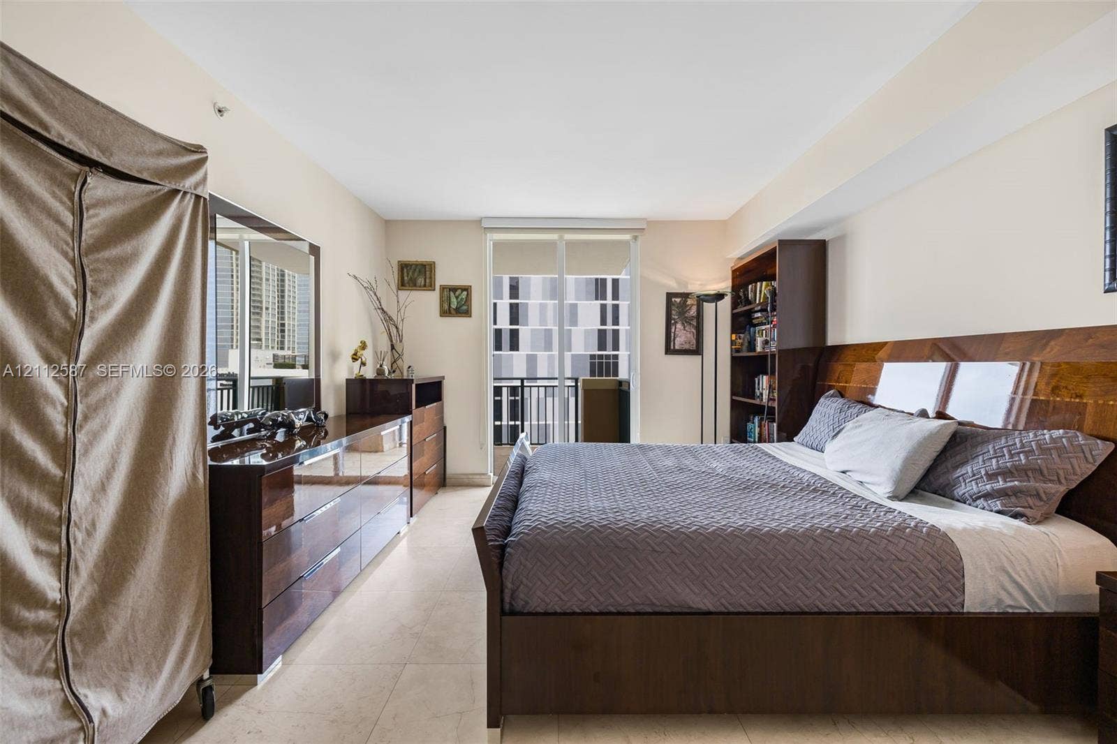 17555 NW Atlantic Boulevard, #1108, Sunny Isles Beach, FL 33160 Sliding glass door opening to a balcony, stone-finish flooring, and high ceilings