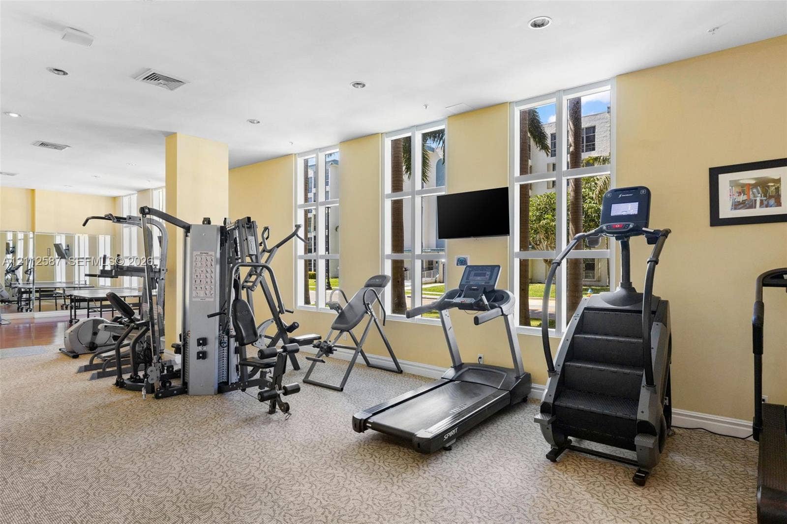 17555 NW Atlantic Boulevard, #1108, Sunny Isles Beach, FL 33160 Fitness center featuring wall-to-wall carpeting, floor-to-ceiling windows, and recessed ceiling lighting