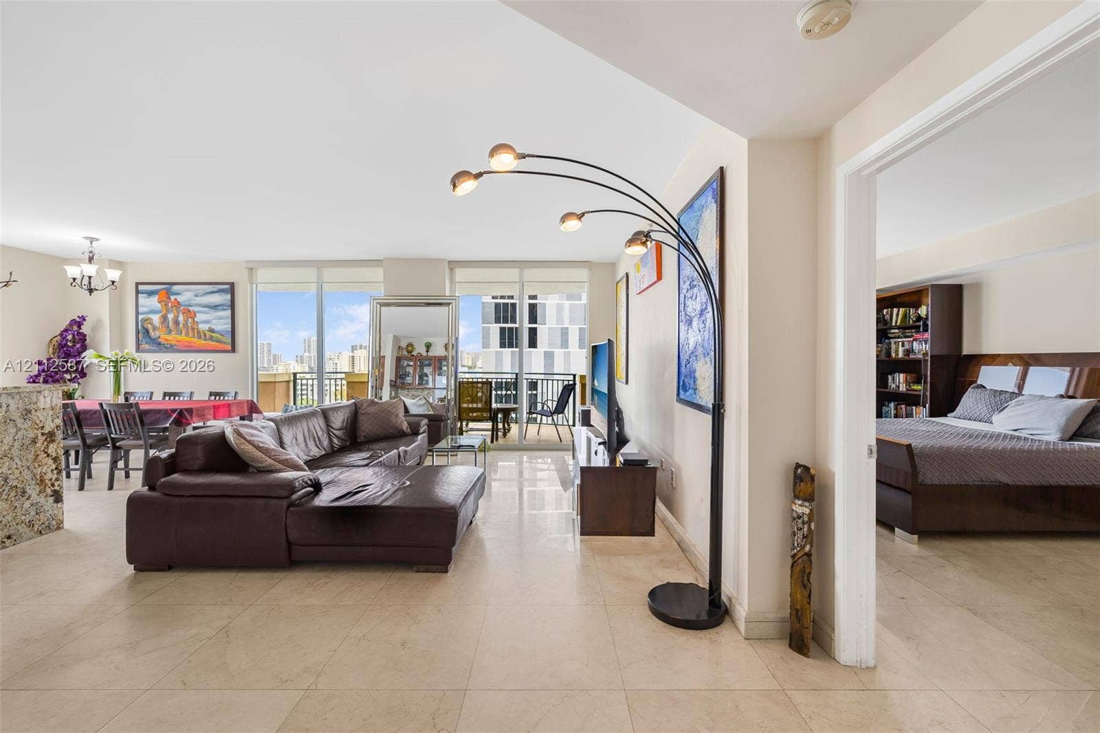 17555 NW Atlantic Boulevard, #1108, Sunny Isles Beach, FL 33160 Large-format stone tile flooring, expansive floor-to-ceiling windows, and private exterior balcony access