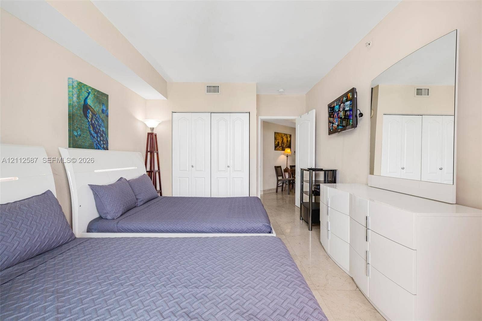 17555 NW Atlantic Boulevard, #1108, Sunny Isles Beach, FL 33160 Neutral-toned interior featuring polished stone flooring, recessed lighting, and double-door closet storage