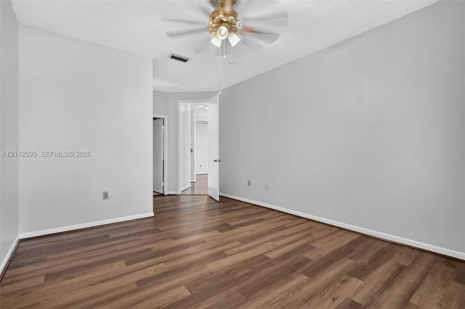 7974 NW 190th Terrace, Hialeah, FL 33015 Neutral interior space featuring wood-finish flooring and a multi-light ceiling fan