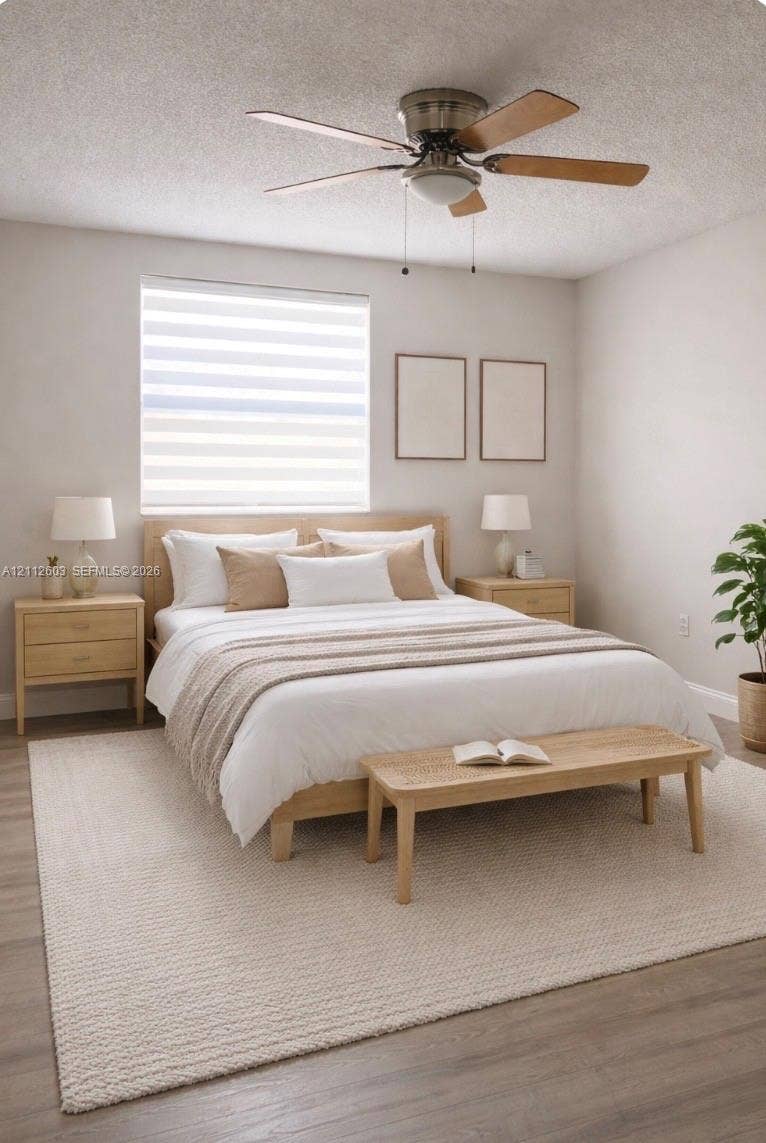 Master bedroom featuring wood-finish flooring, a neutral color palette, tiered roller shades, and a ceiling fan with integrated lighting