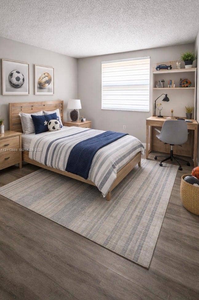 Bedroom featuring wood-finish flooring