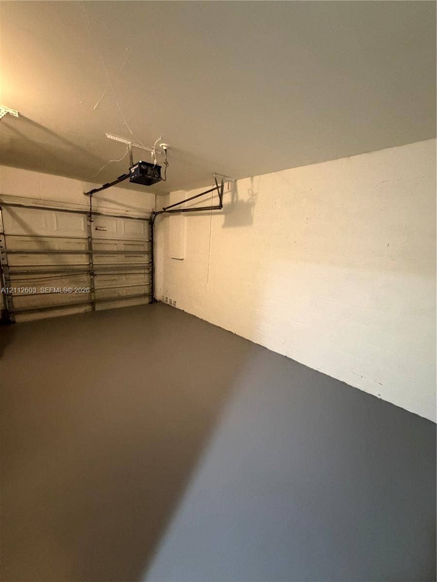 Garage space featuring a painted concrete floor