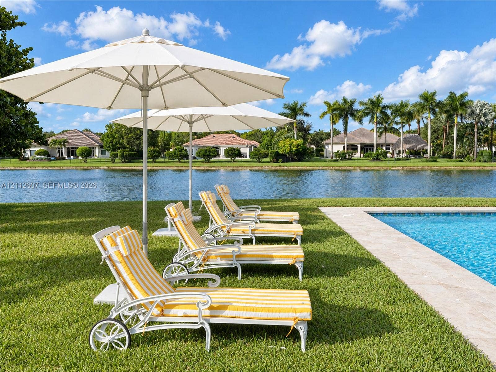 14443 S Jockey Circle S, Davie, FL 33330 Swimming pool with natural stone decking and expansive waterfront lawn