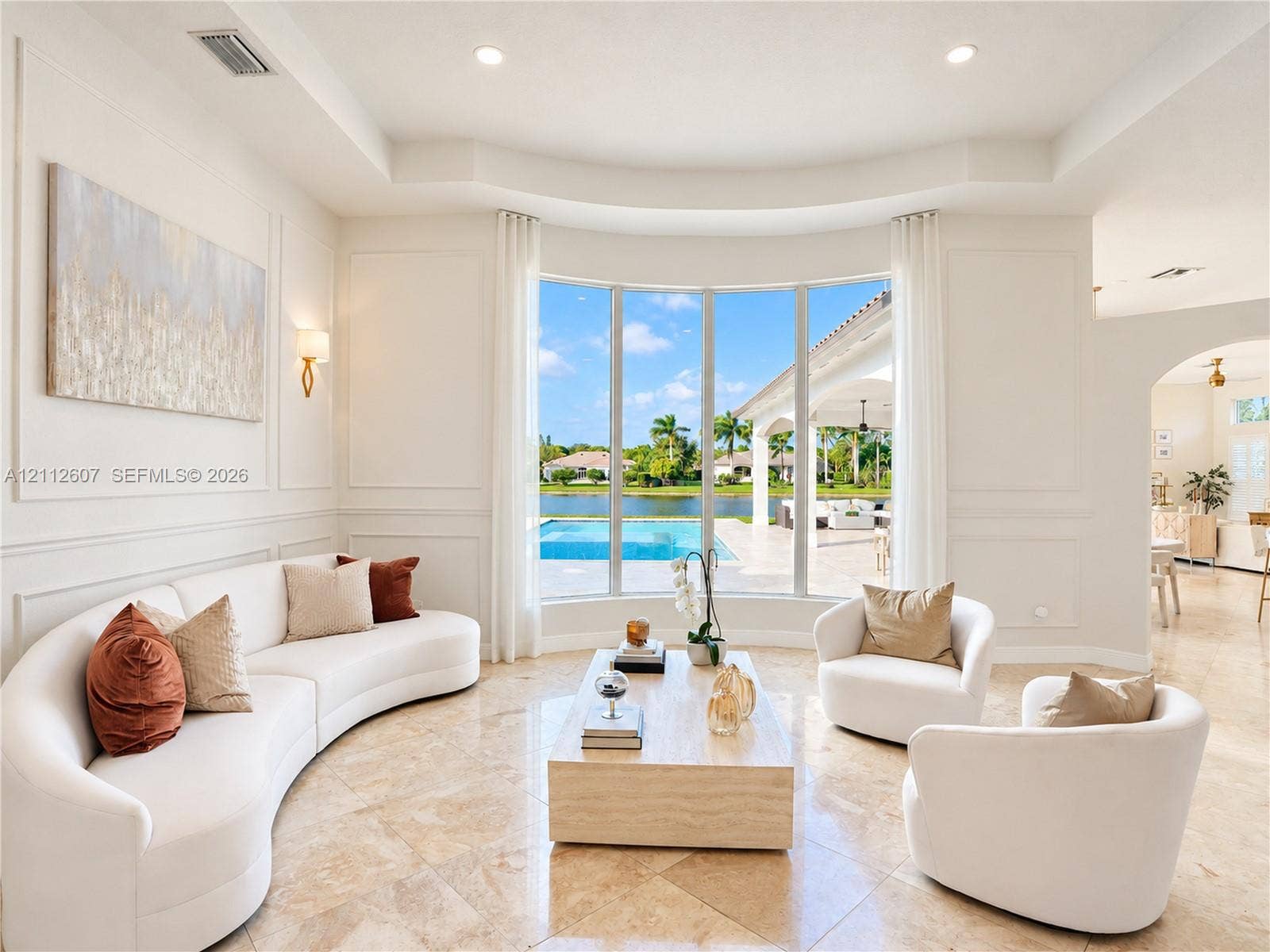 14443 S Jockey Circle S, Davie, FL 33330 Living area featuring large bay windows, recessed ceiling, wall molding, polished stone tile flooring, and wall-mounted light fixtures