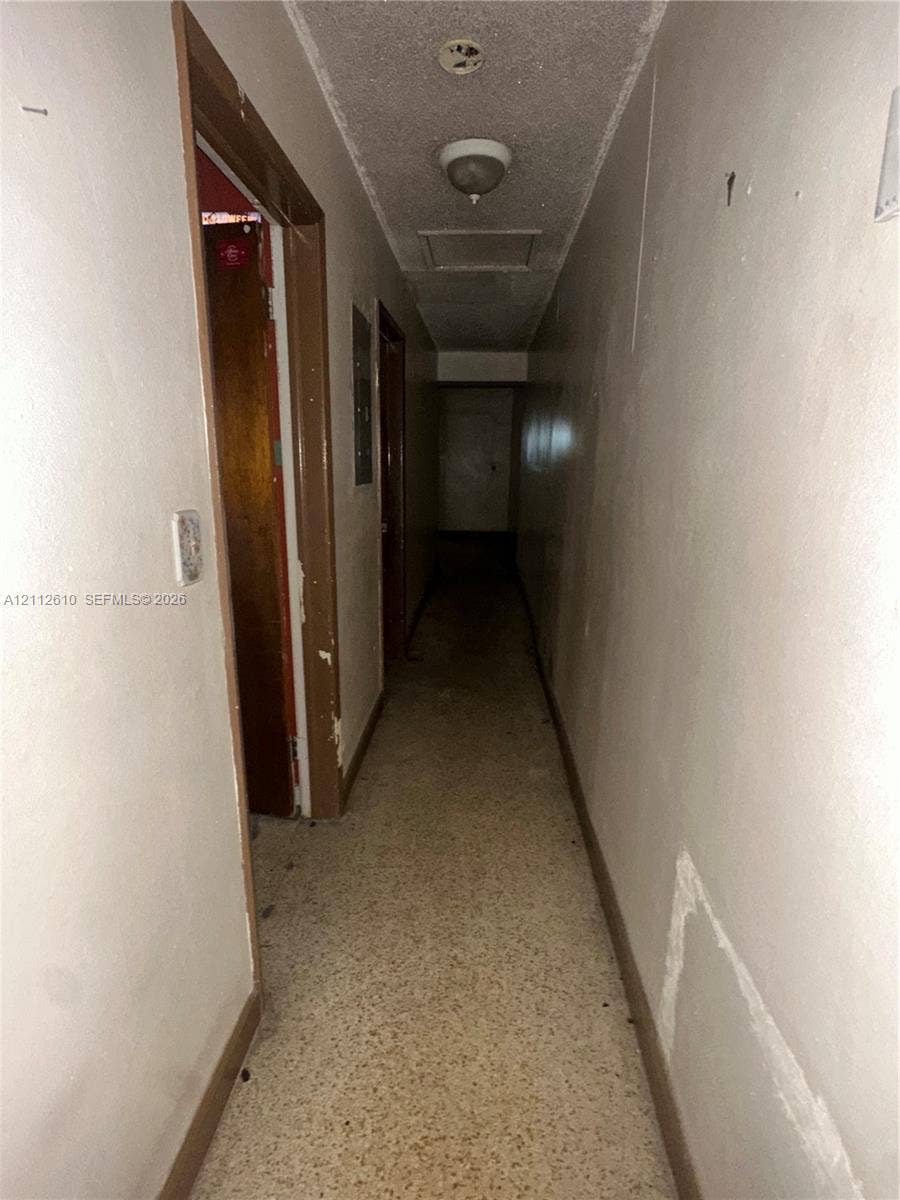 Hialeah, FL 33013 Hallway featuring textured ceiling, flush-mount light fixture, and tile flooring