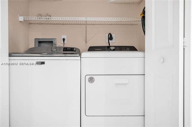 Laundry closet featuring a wire storage shelf and bi-fold door