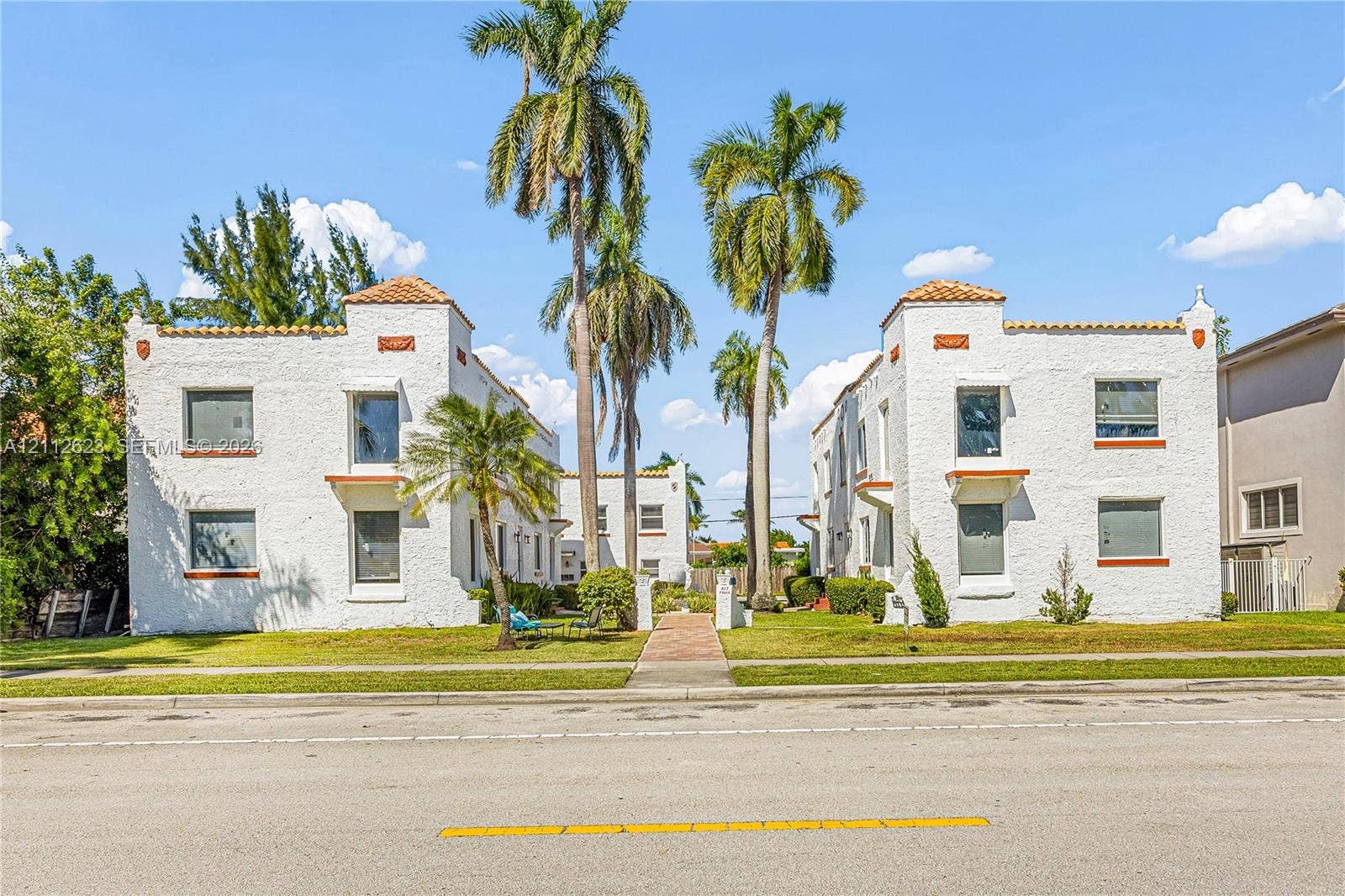 817 Tyler Street, #10, Hollywood, Hollywood, FL 33019 Spanish Revival multi-family architecture featuring white stucco exterior walls, terracotta tile roof accents, and symmetrical multi-level facades
