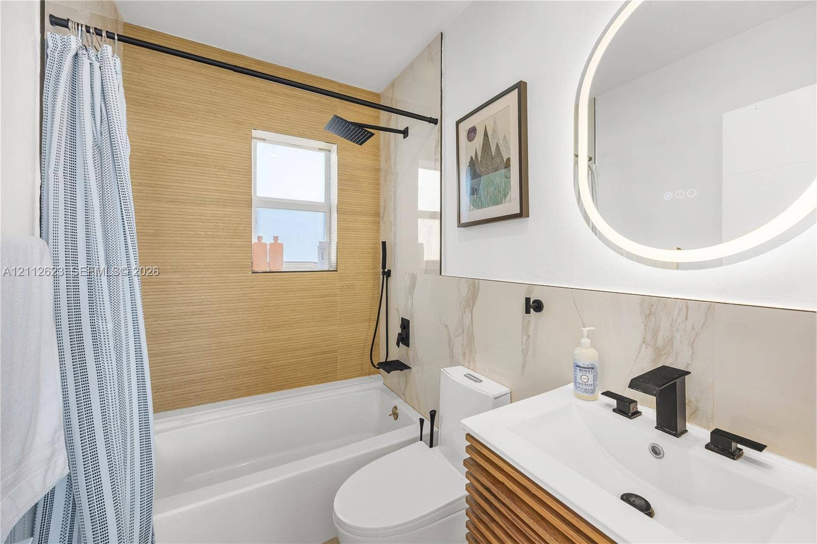 817 Tyler Street, #10, Hollywood, Hollywood, FL 33019 Bathroom featuring a vanity with wood-slat cabinetry, integrated sink, and matte black widespread faucet