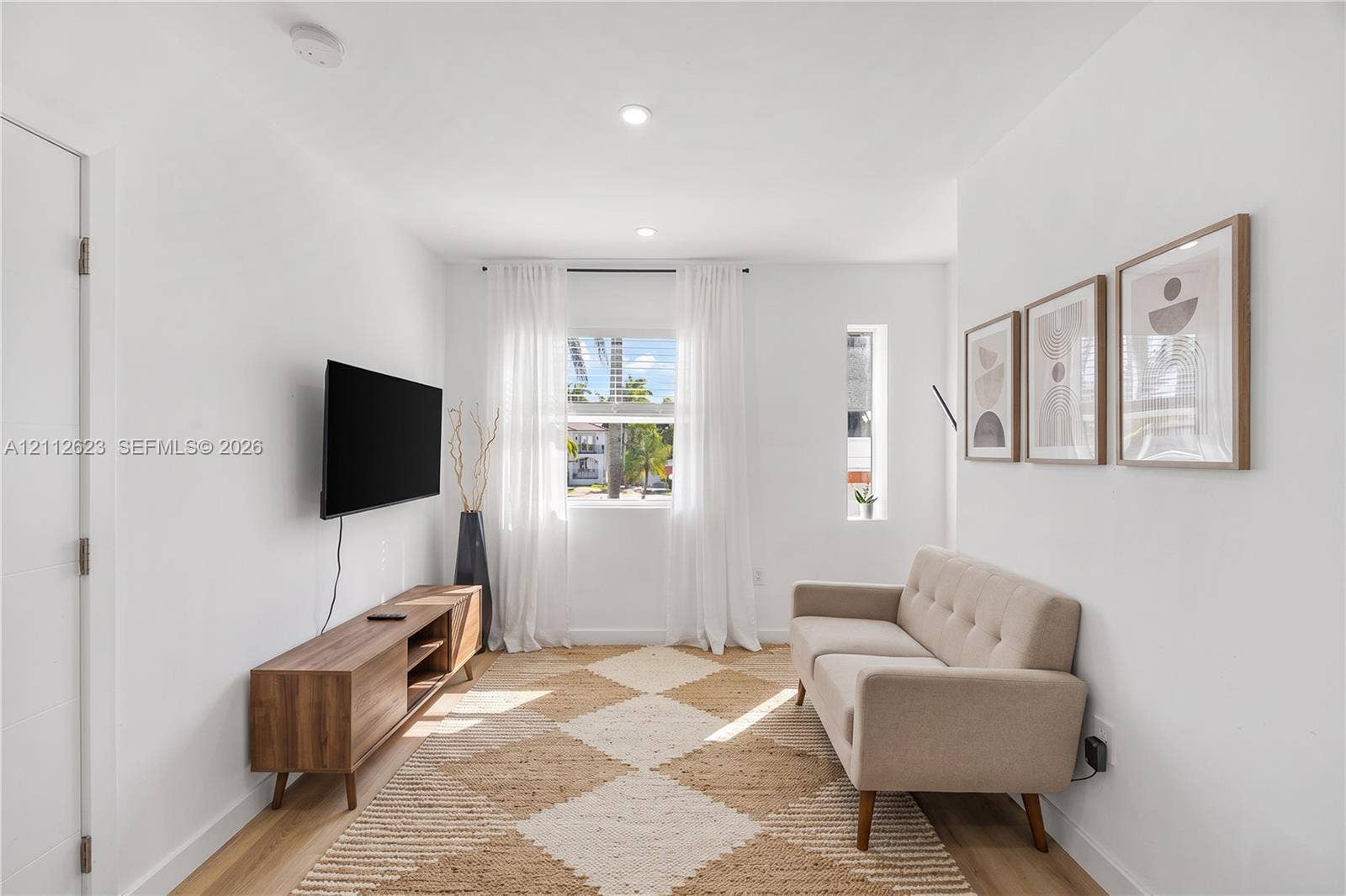 817 Tyler Street, #10, Hollywood, Hollywood, FL 33019 Interior space featuring wood-finish flooring, recessed lighting, and dual-pane window configuration including a vertical fixed-pane window