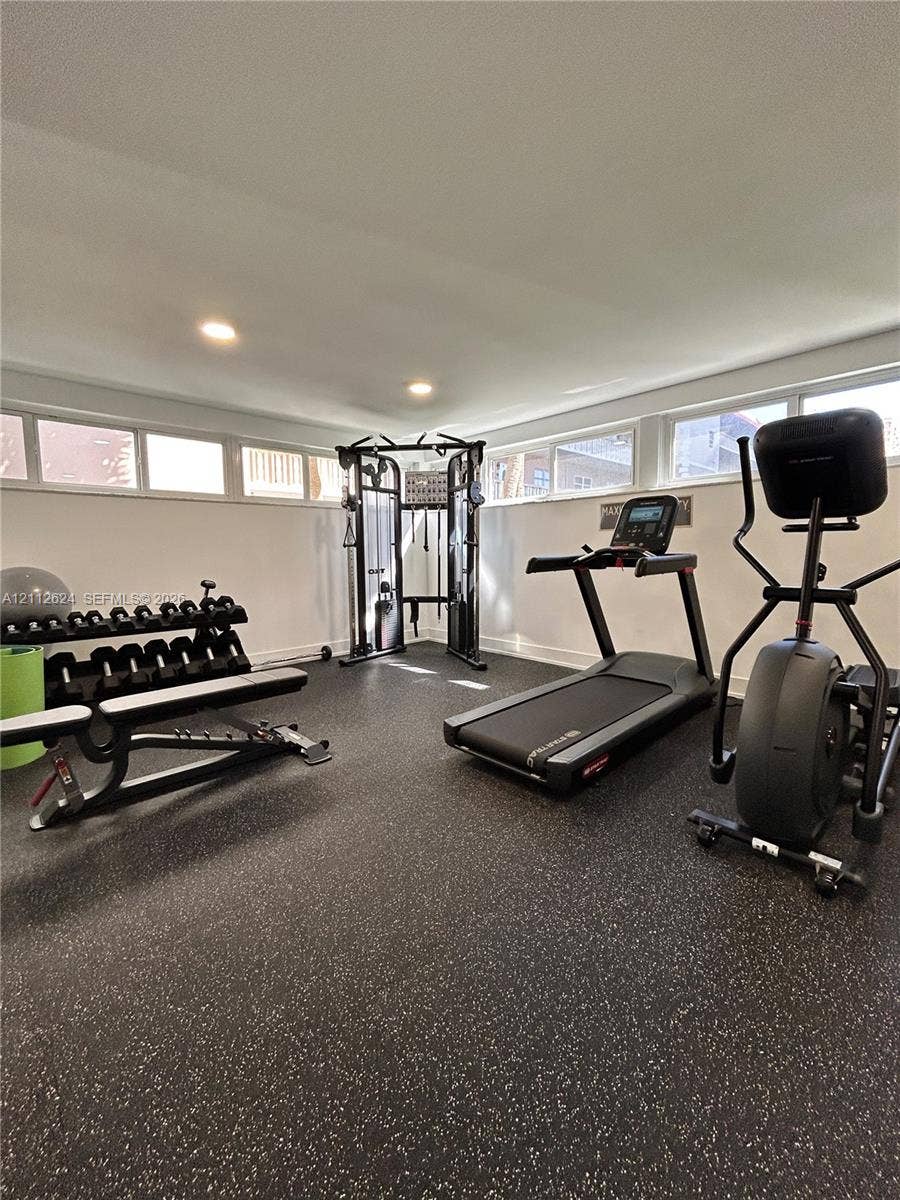 Flex space featuring speckled rubberized flooring, recessed lighting, and horizontal clerestory windows
