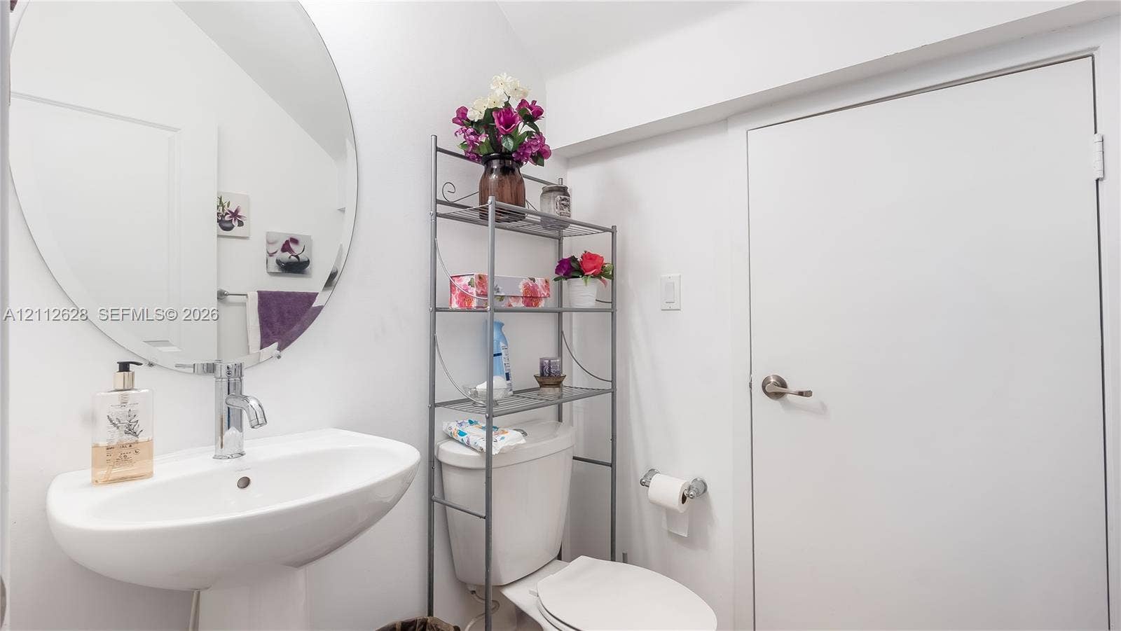4445 NW 48th Terrace, Tamarac, Tamarac, FL 33319 A stylish powder room centrally located among all common areas, featuring a perfect storage nook for cleaning supplies and a surplus of toiletrieskeeping everything organized and out of sight