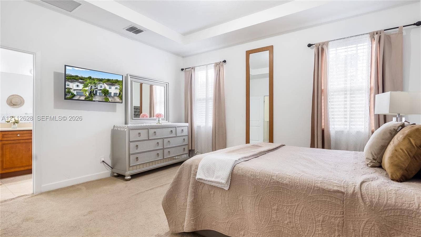 4445 NW 48th Terrace, Tamarac, Tamarac, FL 33319 This refined primary bedroom blends comfort and sophistication, offering ample space to unwind along with a spacious walk-in closet and a beautifully appointed oversized ensuite bathroom designed for resort-style living.