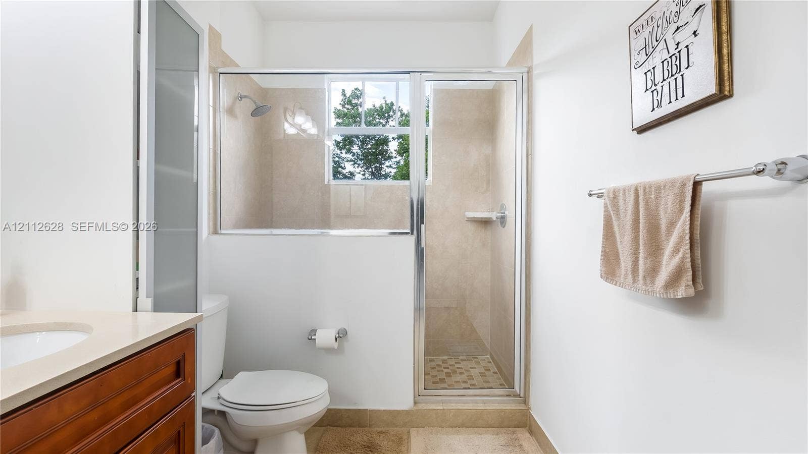 4445 NW 48th Terrace, Tamarac, Tamarac, FL 33319 A luxurious ensuite bathroom complete with an expansive dual-vanity, abundant counter space, and warm finishesdesigned to elevate your morning routine and provide a serene, resort-style experience.