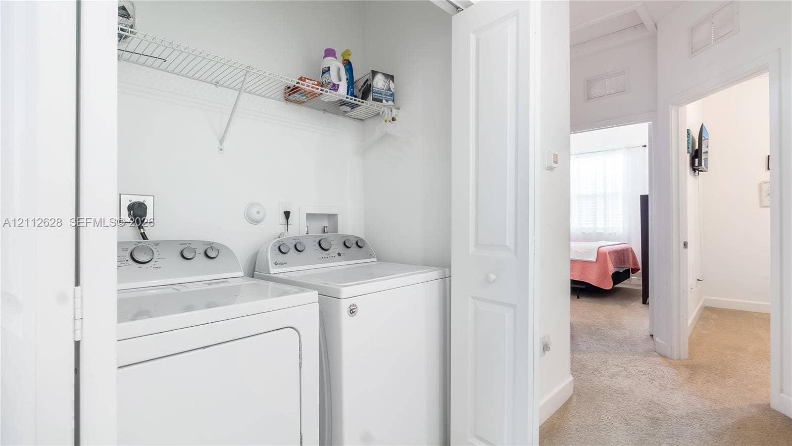 4445 NW 48th Terrace, Tamarac, Tamarac, FL 33319 A convenient upstairs laundry closet with full-size machines and open shelvingdesigned to make everyday routines simple, organized, and efficient.
