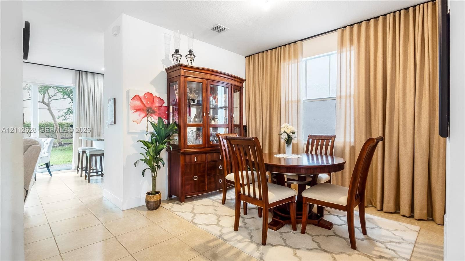 4445 NW 48th Terrace, Tamarac, Tamarac, FL 33319 Framed by beautiful drapery and soft natural light, this dining area elevates every meal into an experienceperfect for both relaxed evenings and special occasions.