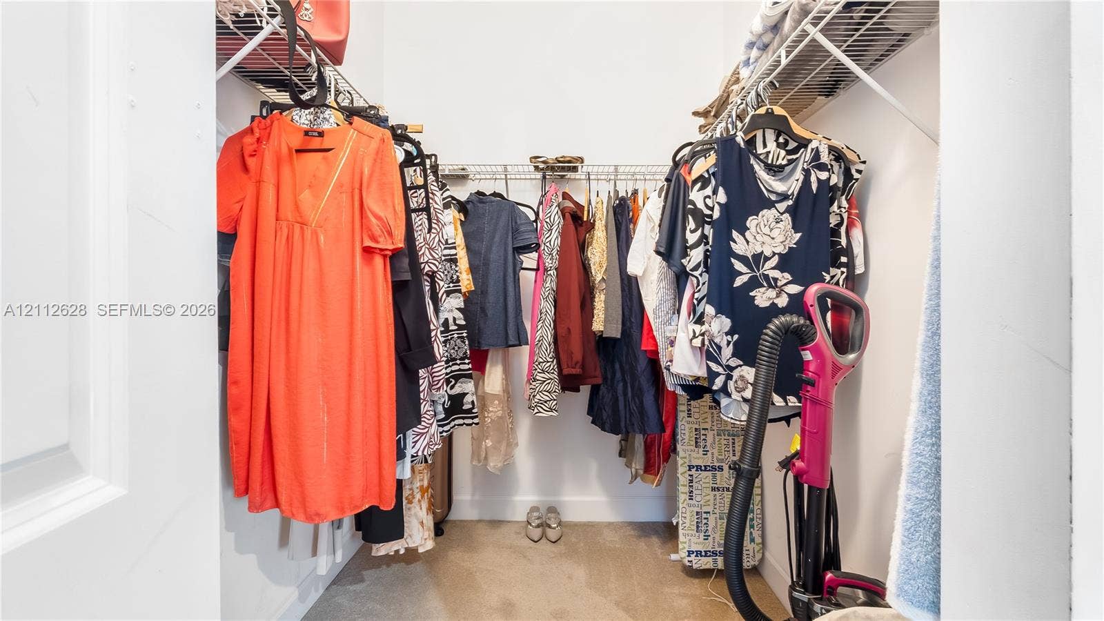 4445 NW 48th Terrace, Tamarac, Tamarac, FL 33319 A spacious walk-in closet offering generous hanging space, open shelving, and effortless organizationperfect for curating your wardrobe and keeping everyday essentials beautifully within reach.