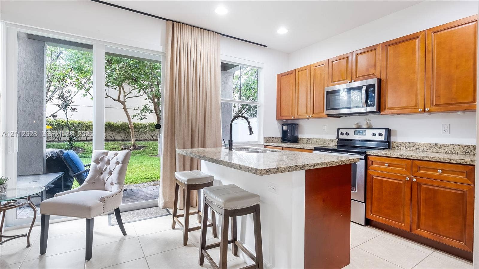 4445 NW 48th Terrace, Tamarac, Tamarac, FL 33319 Bathed in natural light, this chef-inspired kitchen showcases premium stainless steel appliances and a polished granite islandcomplete with elegant seating for effortless, casual dining.