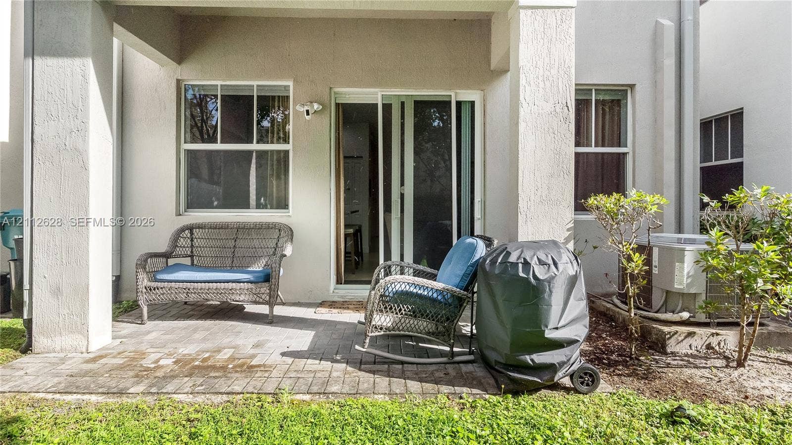 4445 NW 48th Terrace, Tamarac, Tamarac, FL 33319 A peaceful, tree-lined backyard offering a private outdoor escapeperfect for unwinding, enjoying morning coffee, or creating a cozy lounge or play area to suit your lifestyle.