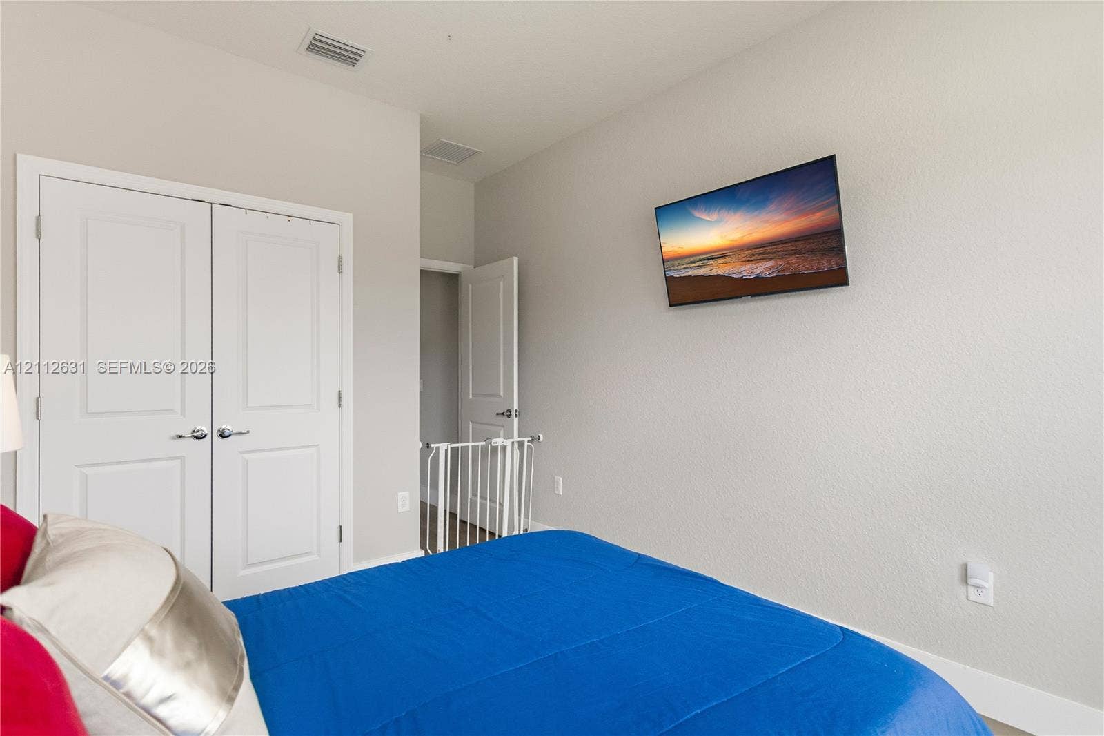 8257 NW 79th Avenue, Tamarac, FL 33321 Neutral-toned room with double-panel doors and a wall-mounted display